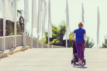 Image showing mom with baby stroller jogging