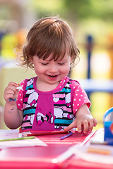 Image showing little girl drawing a colorful pictures