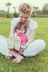 Image showing mother and little daughter playing at backyard