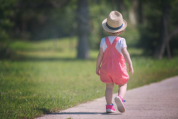 Image showing little girl runing in the summer Park