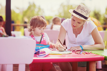 Image showing mom and little daughter drawing a colorful pictures