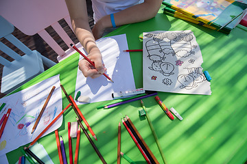 Image showing closeup of hands drawing a colorful pictures