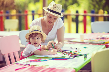 Image showing mom and little daughter drawing a colorful pictures