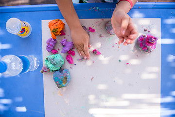 Image showing kid hands Playing with Colorful Clay