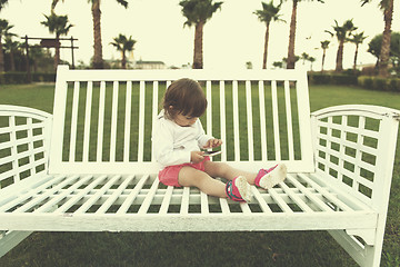 Image showing little girl playing with mobile phone