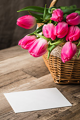 Image showing Beautiful bouquet of pink tulips and congratulations on the tabl