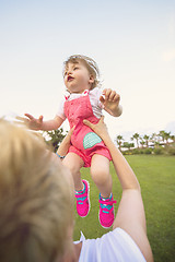 Image showing mother and little daughter playing at backyard