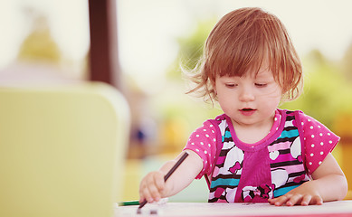 Image showing little girl drawing a colorful pictures