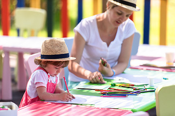 Image showing mom and little daughter drawing a colorful pictures