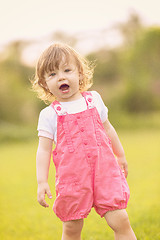 Image showing little girl spending time at backyard