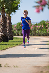 Image showing young female runner training for marathon