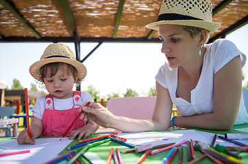 Image showing mom and little daughter drawing a colorful pictures