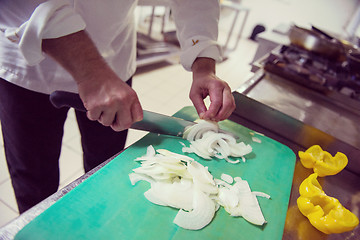 Image showing Chef hands cutting fresh and delicious vegetables