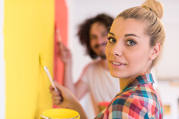 Image showing couple painting interior wall