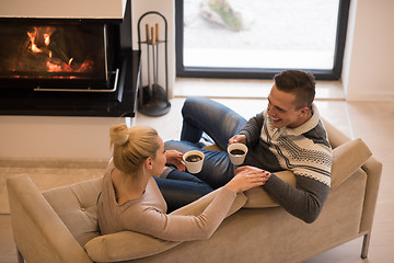 Image showing Young couple  in front of fireplace