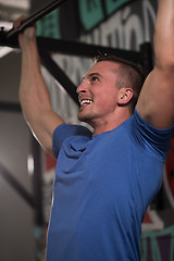 Image showing man doing pull ups