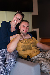 Image showing young handsome couple hugging on the sofa