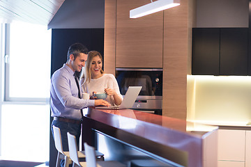 Image showing A young couple is preparing for a job and using a laptop