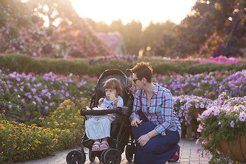 Image showing mother and daughter in flower garden