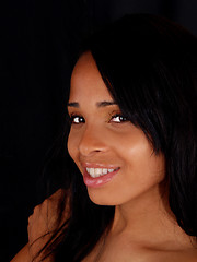 Image showing Young black woman smiling portrait dark background