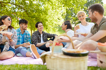 Image showing happy friends eating sandwiches at summer picnic