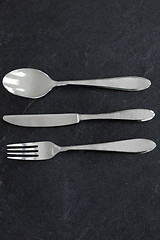 Image showing close up of fork, knife and spoon on table