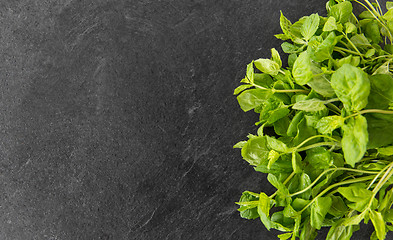 Image showing green mint leaves on stone background