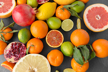 Image showing close up of citrus fruits on stone table