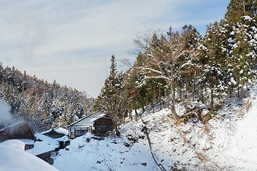 Image showing country houses and forest hills in winter, japan