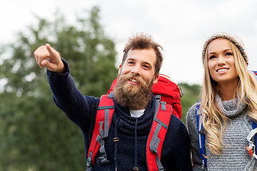 Image showing couple of travelers with backpacks hiking