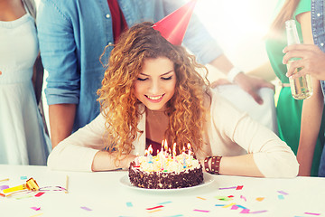 Image showing happy woman with birthday cake at home party