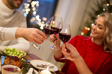 Image showing close up of friends with wine celebrate christmas