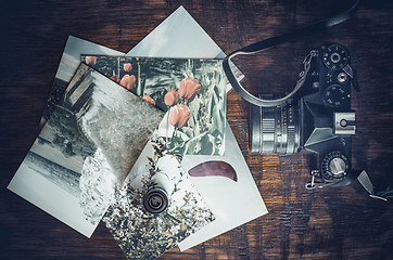 Image showing Old photo film roll and retro camera on desk