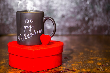 Image showing Valentine's day concept with black cup, chalk inscription on a mug and a red heart