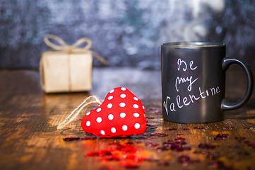 Image showing Valentine's day concept with black cup, chalk inscription on a mug and a red heart