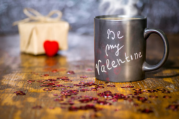 Image showing Valentine's day concept with black cup, chalk inscription on a mug and a red heart