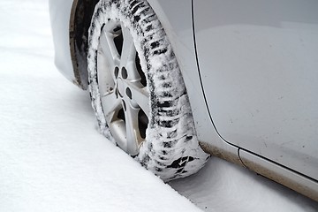 Image showing Car tyre in snow