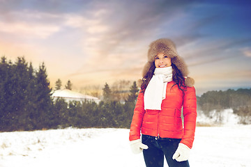 Image showing happy woman in fur hat over winter background