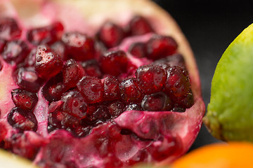 Image showing close up of pomegranate on stone table