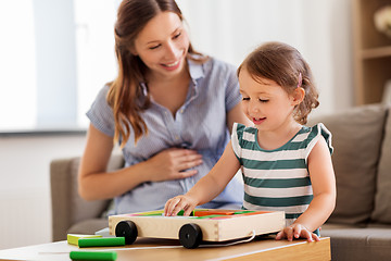 Image showing pregnant mother and daughter with toy blocks