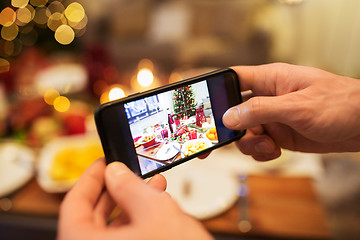 Image showing hands photographing food at christmas dinner