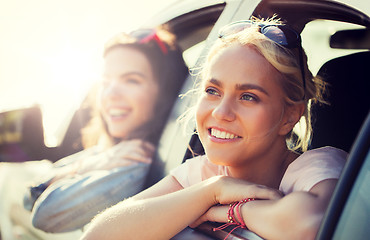 Image showing happy teenage girls or women in car at seaside