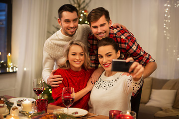 Image showing friends taking selfie at christmas dinner