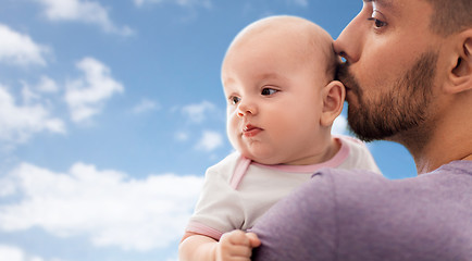 Image showing close up of father kissing little baby daughter