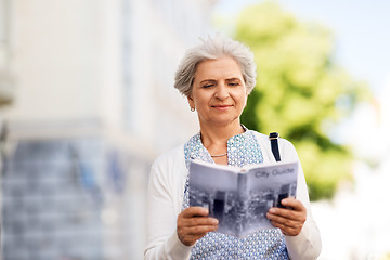 Image showing senior woman or tourist with city guide outdoors