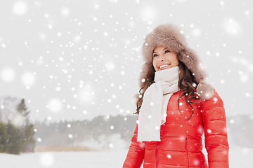 Image showing happy woman in winter fur hat outdoors