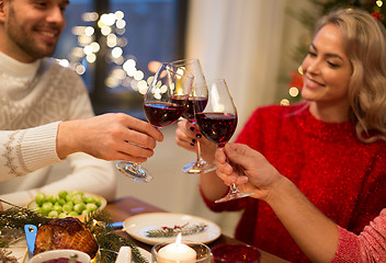 Image showing close up of friends with wine celebrate christmas