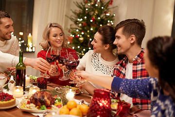 Image showing friends celebrating christmas and drinking wine