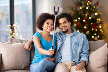 Image showing couple with smartphone taking selfie on christmas