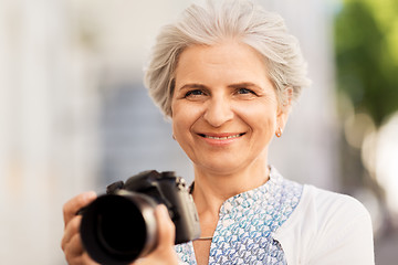 Image showing senior woman photographing by digital camera